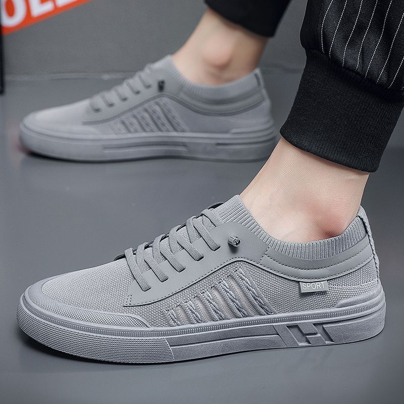 Men's gray casual skateboard shoes with solid color and mesh lining.