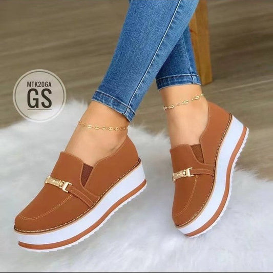 Women's slip-on flat sneakers in light brown with a unique, stylish design and platform muffin heel.